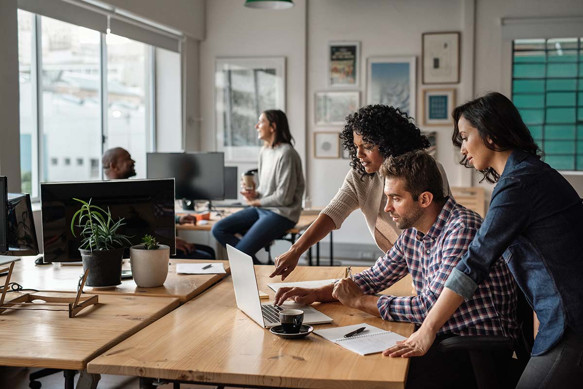 Team collaborating in an office, highlighting teamwork in small business marketing strategies.