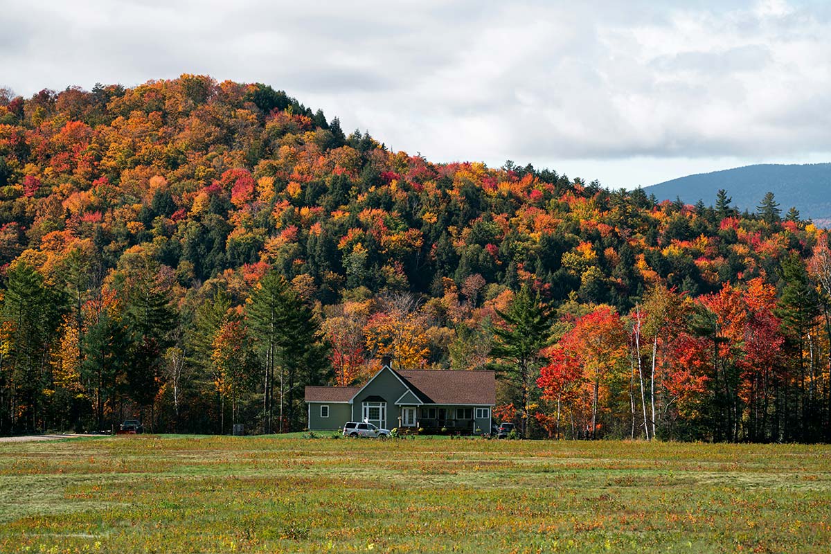 House in early autumn landscape in Western Massachusetts, example of local brands in Western Massachusetts connecting with rural communities