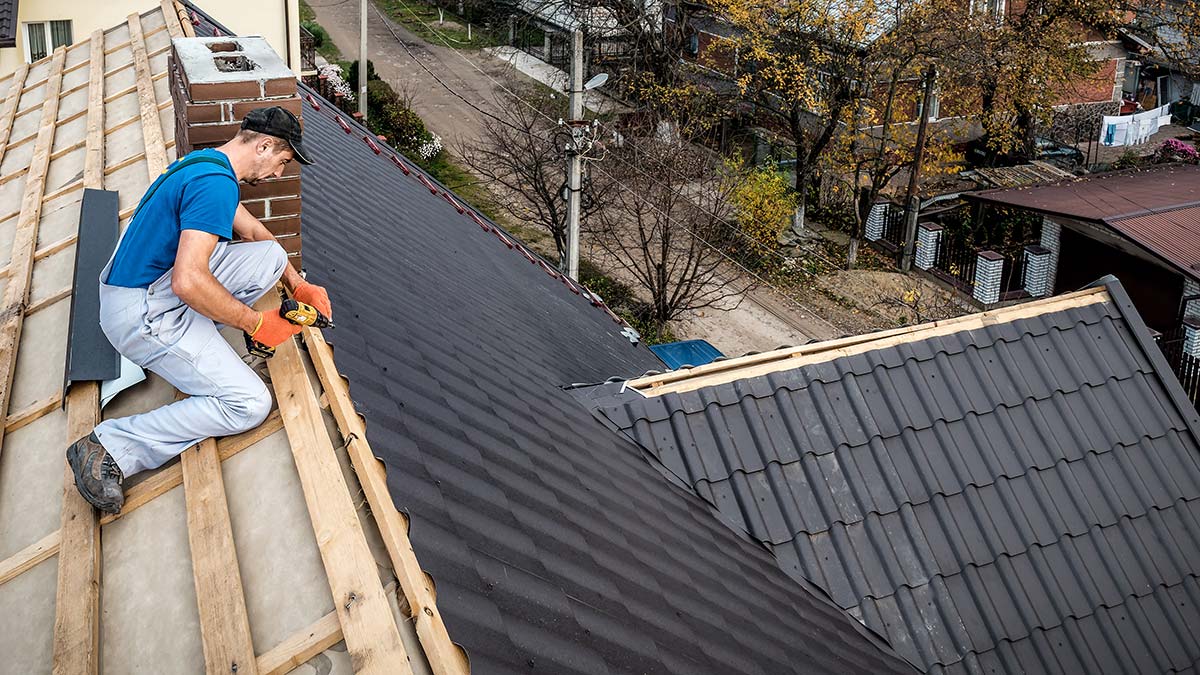 Professional roofer installing a metal roof as part of a roofing marketing guide for contractors