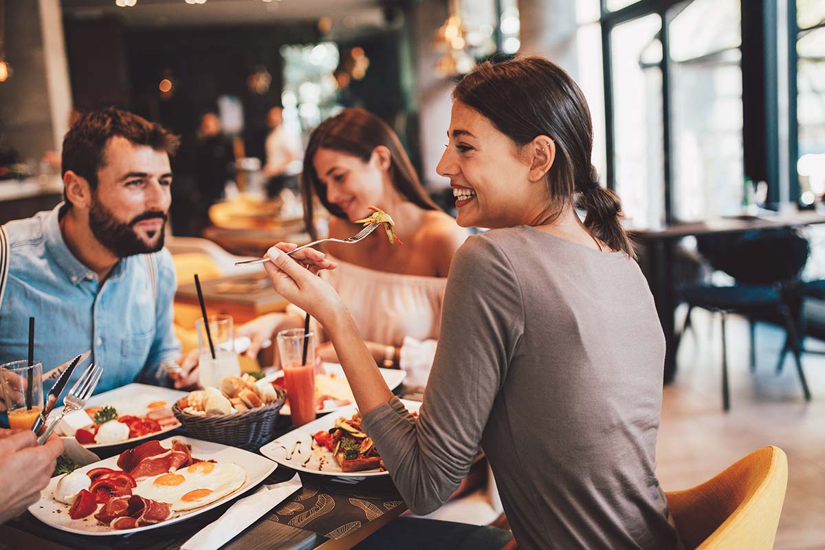 Diners enjoying a meal together at a restaurant, reflecting the passion for great food and customer service.